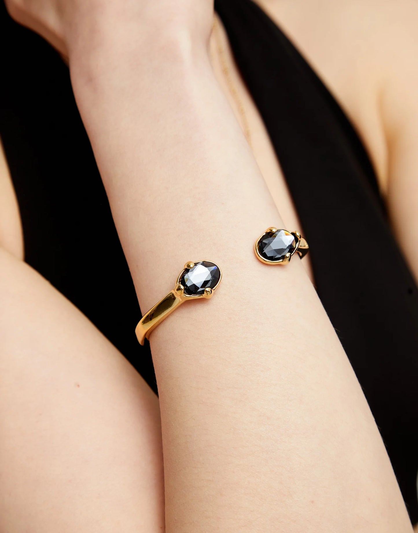Bangle bracelet with two faceted black oval crystals