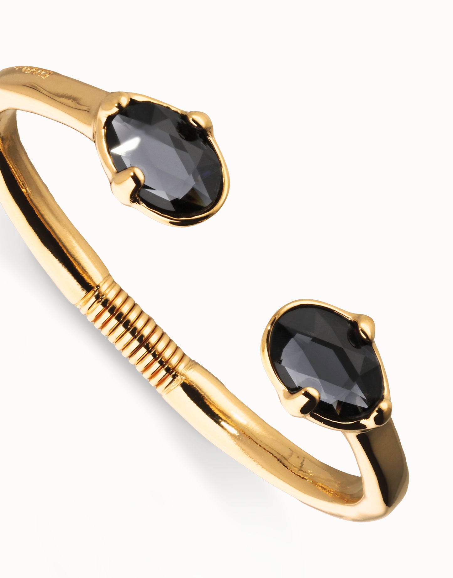 Bangle bracelet with two faceted black oval crystals