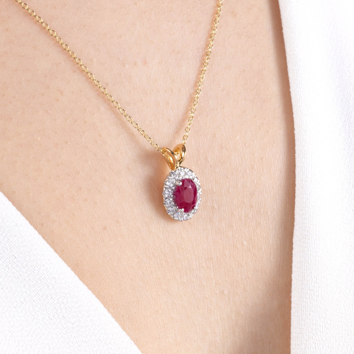 Emerald and Diamond Oval Halo Pendant
